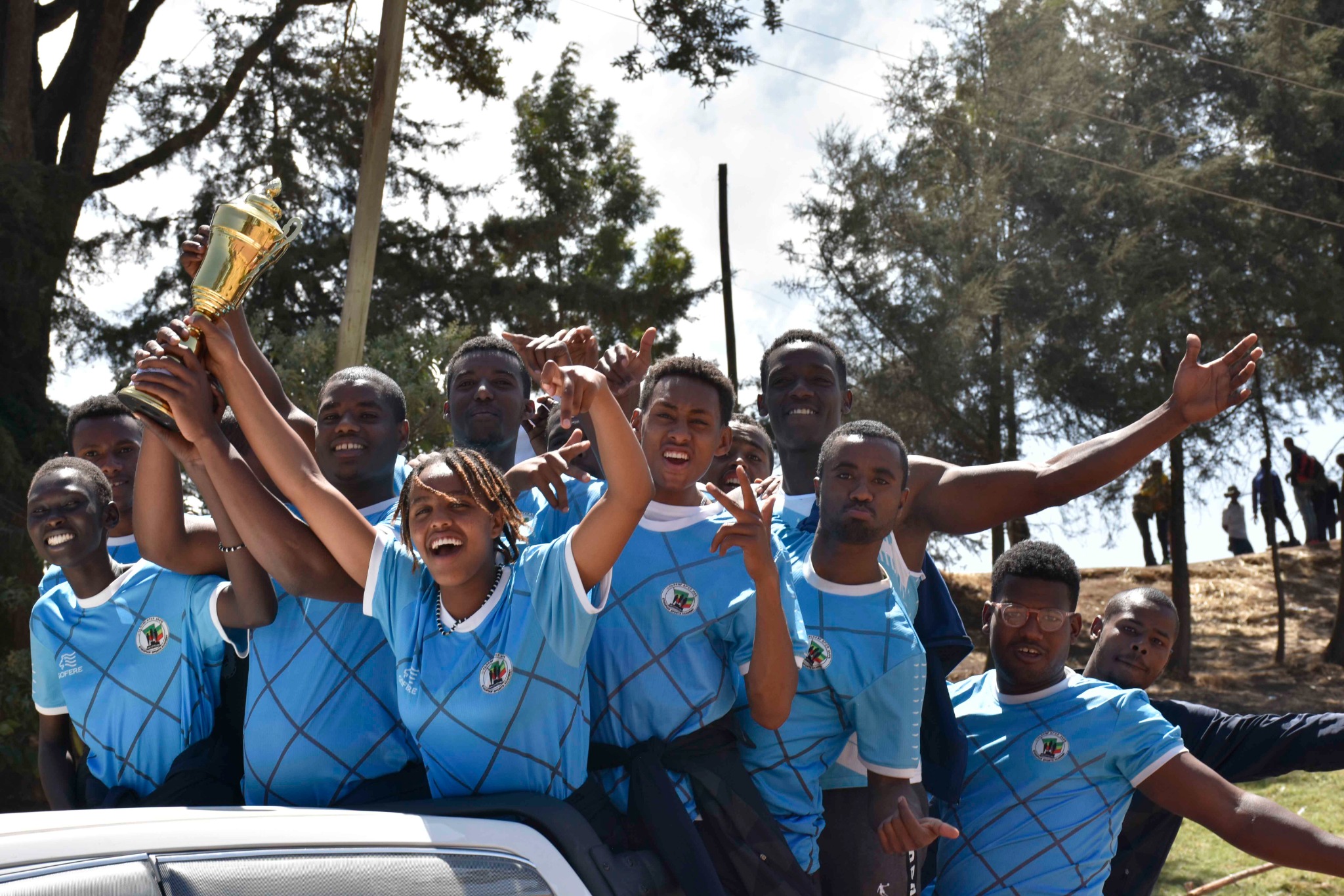 Academy athletes celebrating with a trophy